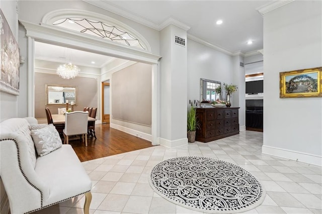 tiled foyer featuring crown molding, a notable chandelier, recessed lighting, baseboards, and visible vents
