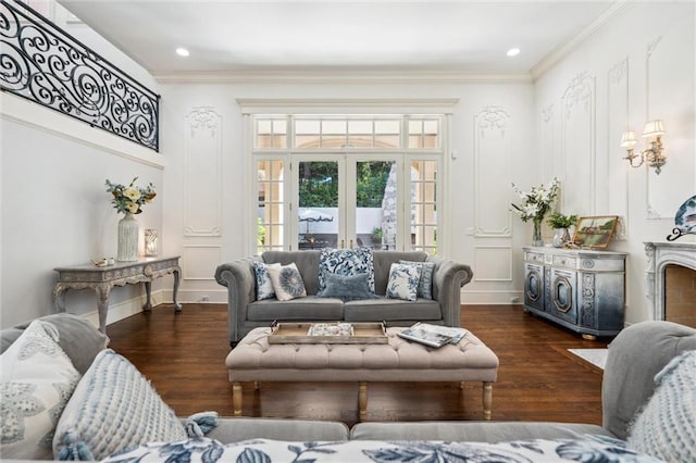 living area featuring crown molding, recessed lighting, a decorative wall, and wood finished floors