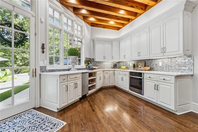kitchen featuring light countertops, beamed ceiling, stainless steel oven, and dark wood-style floors