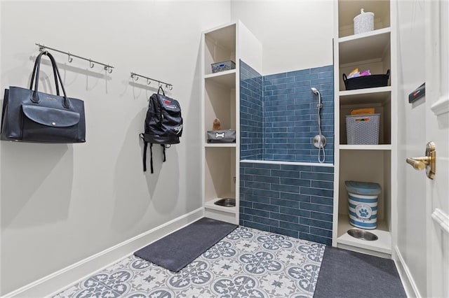 walk in closet with tile patterned flooring