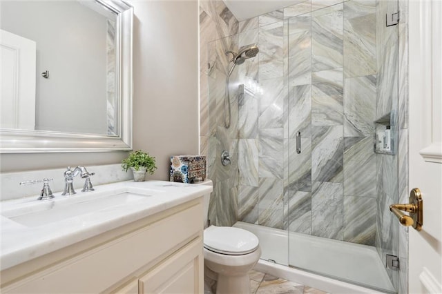 bathroom featuring vanity, a shower stall, toilet, and marble finish floor