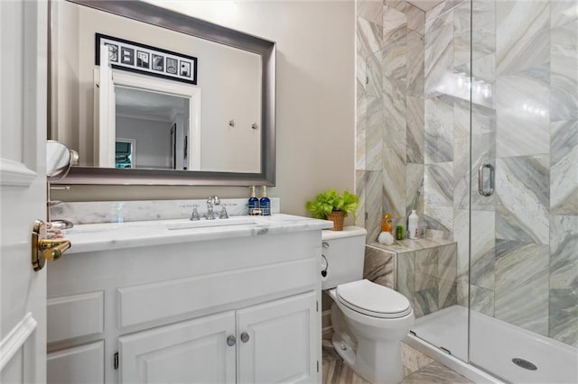 bathroom with vanity, a stall shower, and toilet
