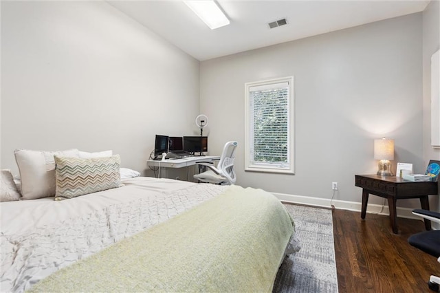 bedroom featuring baseboards, dark wood finished floors, and lofted ceiling