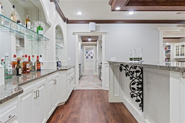 bar with a dry bar, a sink, ornamental molding, recessed lighting, and dark wood-style floors