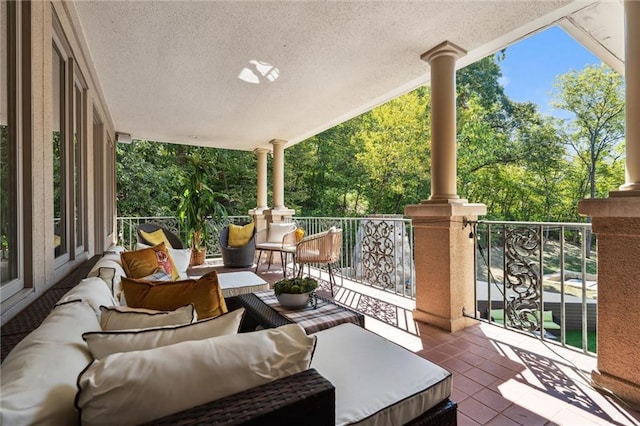 view of patio featuring an outdoor hangout area and a balcony