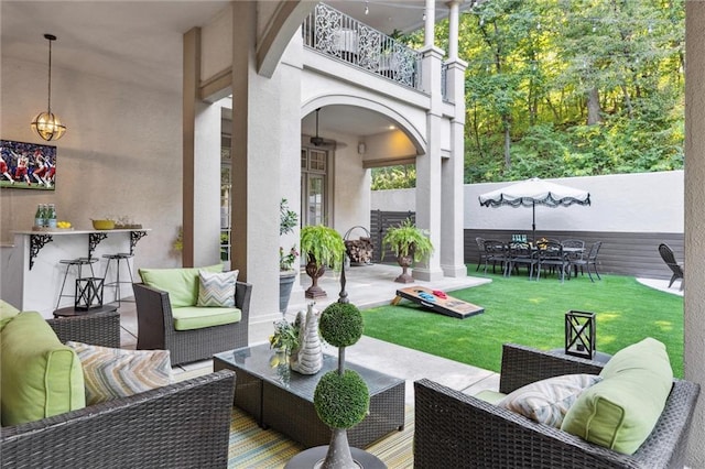 view of patio featuring outdoor lounge area, a balcony, and outdoor dry bar