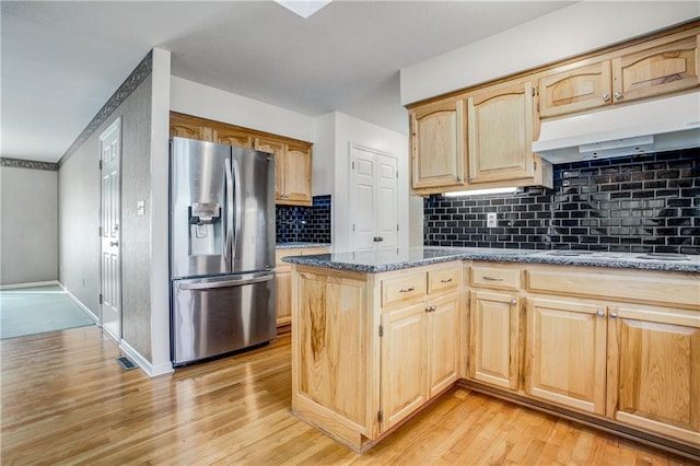 22804 E 28th Terrace Ct, Blue Springs, MO 64015 - kitchen with stainless steel refrigerator with ice dispenser, light wood finished floors, under cabinet range hood, dark stone countertops, and white electric cooktop