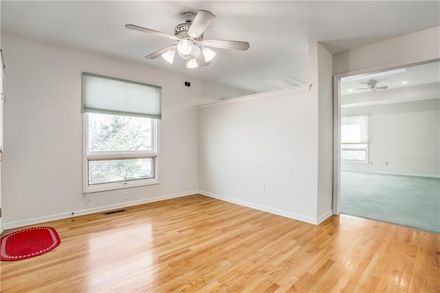 22804 E 28th Terrace Ct, Blue Springs, MO 64015 - unfurnished room with a ceiling fan, plenty of natural light, light wood-style floors, and baseboards