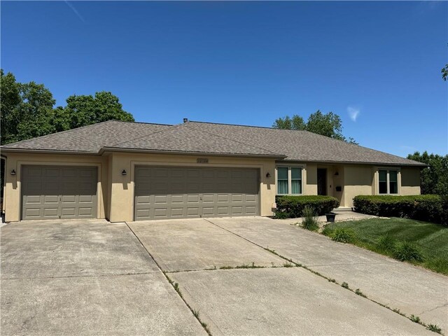 22804 E 28th Terrace Ct, Blue Springs, MO 64015 - ranch-style home with an attached garage, concrete driveway, stucco siding, a front lawn, and roof with shingles