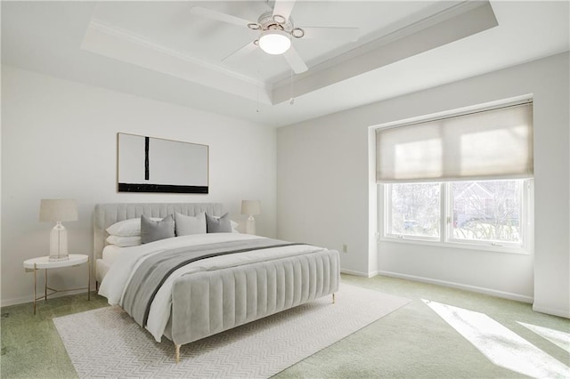 22804 E 28th Terrace Ct, Blue Springs, MO 64015 - bedroom featuring a tray ceiling, light carpet, crown molding, baseboards, and a ceiling fan