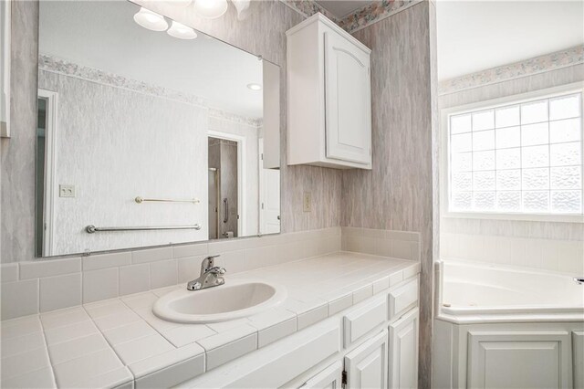 22804 E 28th Terrace Ct, Blue Springs, MO 64015 - full bath featuring wallpapered walls, vanity, and a garden tub