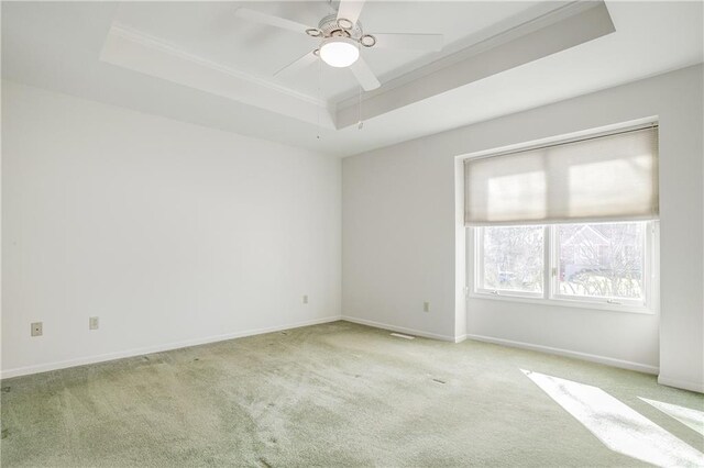 22804 E 28th Terrace Ct, Blue Springs, MO 64015 - unfurnished room featuring a tray ceiling, carpet, baseboards, ceiling fan, and crown molding