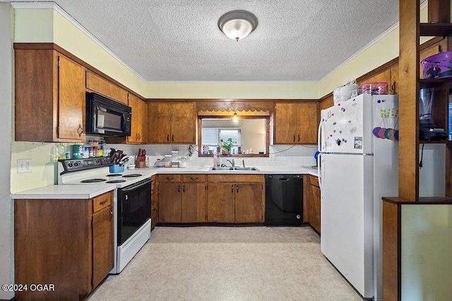 104 W Highland Ave, Nevada, MO 64772 - kitchen with a sink, light countertops, brown cabinetry, and black appliances