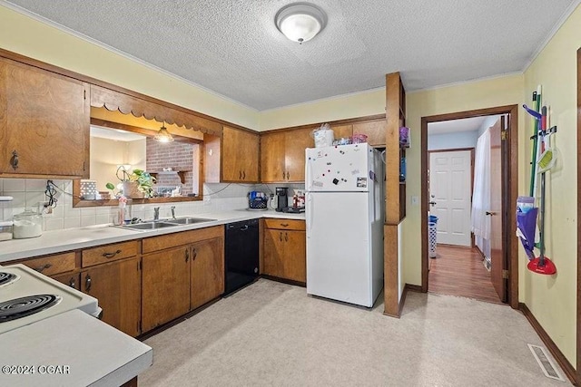 104 W Highland Ave, Nevada, MO 64772 - kitchen featuring a sink, visible vents, white appliances, and brown cabinets