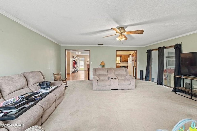 104 W Highland Ave, Nevada, MO 64772 - carpeted living area featuring a textured ceiling, ceiling fan, ornamental molding, and visible vents