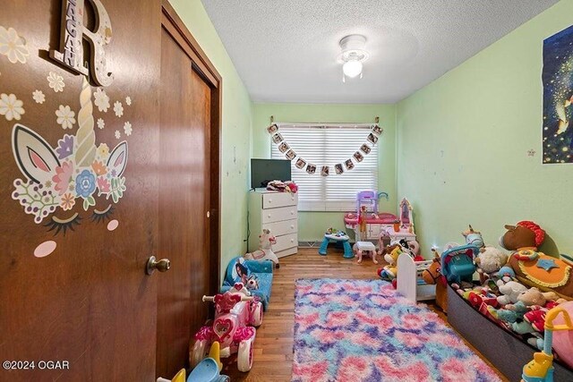 104 W Highland Ave, Nevada, MO 64772 - bedroom with a closet, wood finished floors, and a textured ceiling