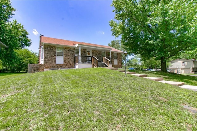 308 Acorn Pl, Warrensburg, MO 64093 - rear view of house featuring a porch, a chimney, a lawn, and brick siding