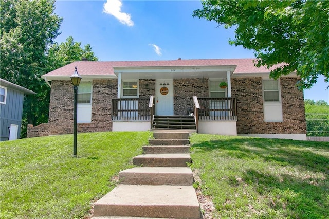 308 Acorn Pl, Warrensburg, MO 64093 - ranch-style house featuring brick siding, a porch, and a front yard