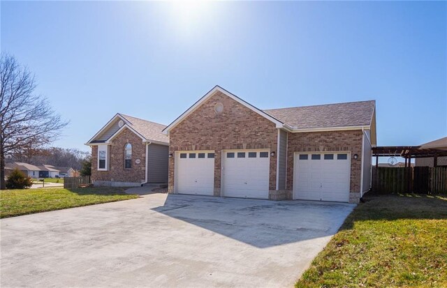 ranch-style house featuring a shingled roof, a front lawn, fence, driveway, and an attached garage