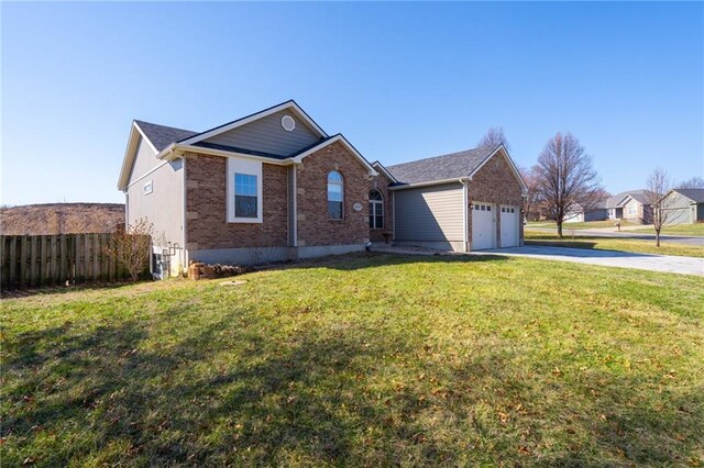 ranch-style house with fence, driveway, an attached garage, a front lawn, and brick siding