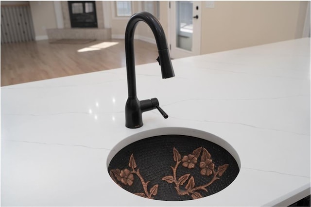 interior details with a sink and wood finished floors