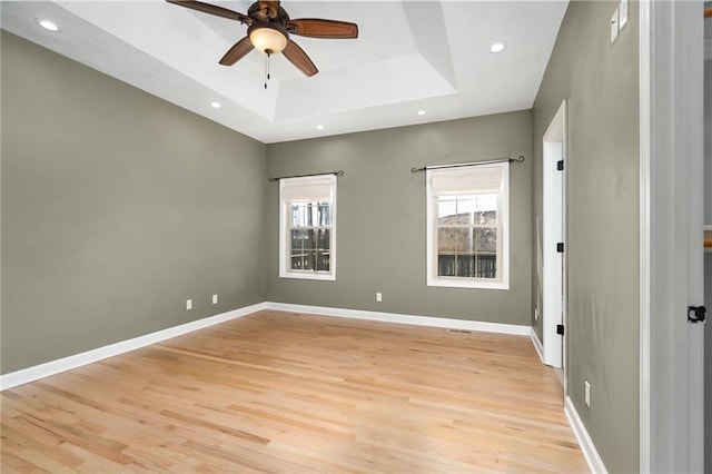 unfurnished room with recessed lighting, baseboards, a tray ceiling, and a ceiling fan
