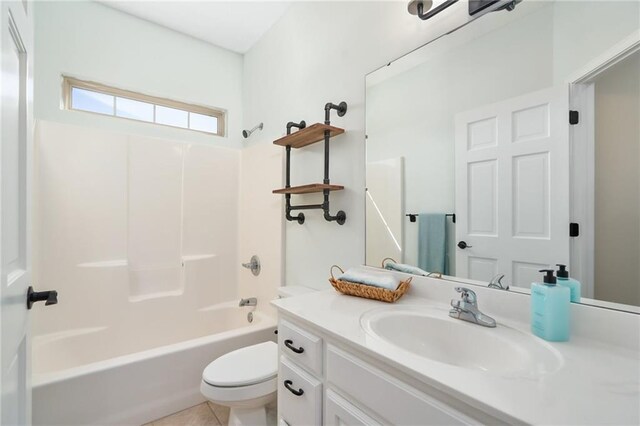 full bath featuring vanity,  shower combination, toilet, and tile patterned floors