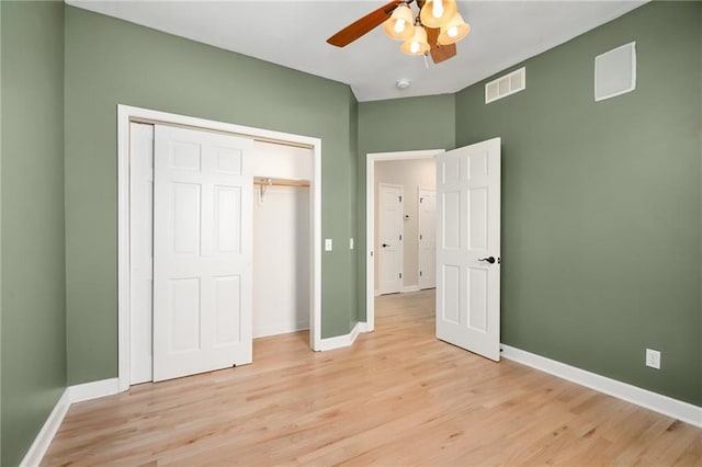 unfurnished bedroom with light wood-type flooring, visible vents, and baseboards