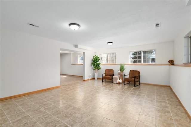 living area featuring visible vents and baseboards
