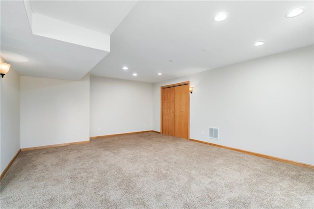 unfurnished room featuring recessed lighting, visible vents, baseboards, and carpet