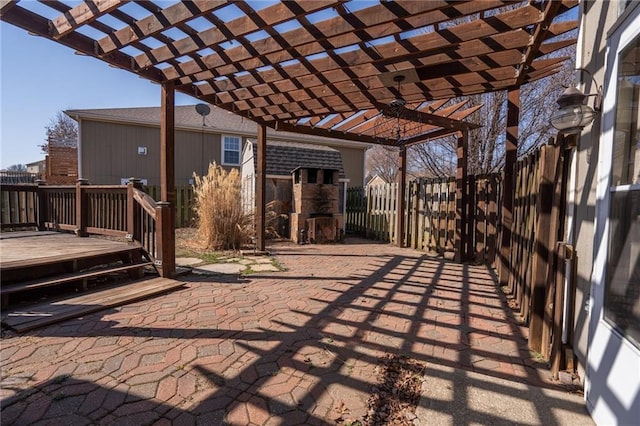 view of patio featuring a deck, fence, and a pergola