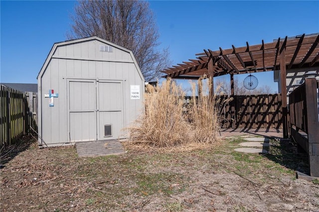 view of shed with a fenced backyard and a pergola
