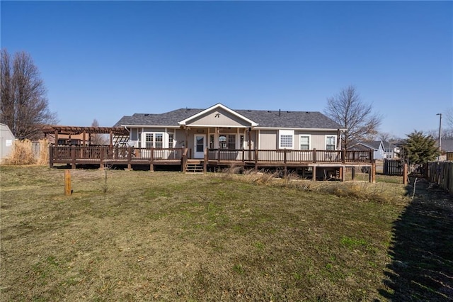 back of house featuring a wooden deck, a lawn, and fence