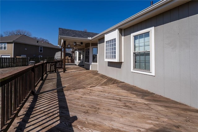 wooden terrace with fence and ceiling fan