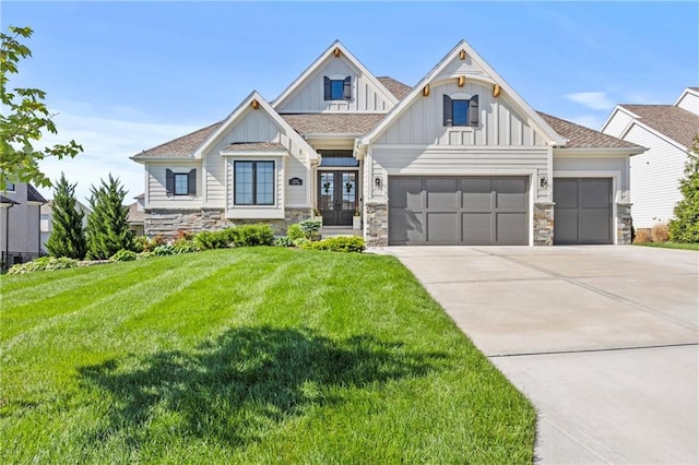 12313 W 169th St, Overland Park, KS 66221 - view of front of house with a garage, board and batten siding, concrete driveway, a front yard, and french doors