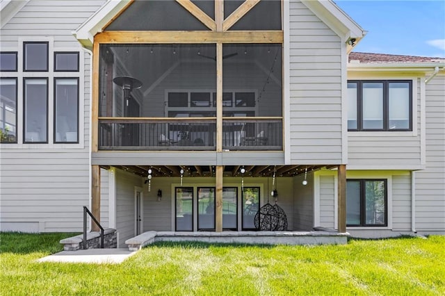 12313 W 169th St, Overland Park, KS 66221 - rear view of house with a sunroom and a lawn