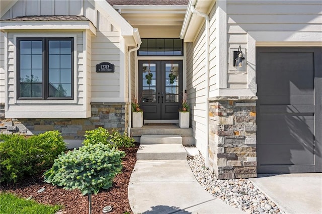 12313 W 169th St, Overland Park, KS 66221 - property entrance featuring french doors, stone siding, and board and batten siding