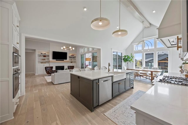 12313 W 169th St, Overland Park, KS 66221 - kitchen featuring appliances with stainless steel finishes, beamed ceiling, light countertops, light wood-type flooring, and a chandelier