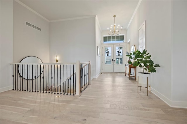 12313 W 169th St, Overland Park, KS 66221 - foyer with wood finished floors, a chandelier, crown molding, and french doors