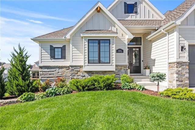 12313 W 169th St, Overland Park, KS 66221 - view of front of home featuring board and batten siding, stone siding, a front yard, and roof with shingles