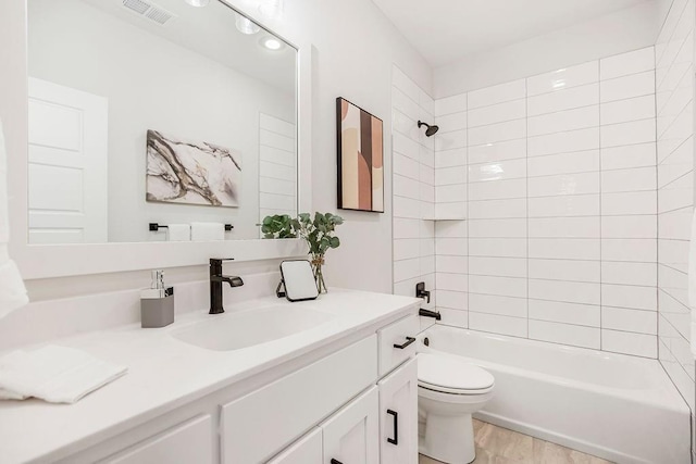 13021 W 174th Pl, Overland Park, KS 66221 - bathroom with toilet, vanity, bathtub / shower combination, and wood finished floors