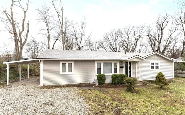 607 SW 8th St, Blue Springs, MO 64015 - view of front facade featuring a carport, gravel driveway, and fence
