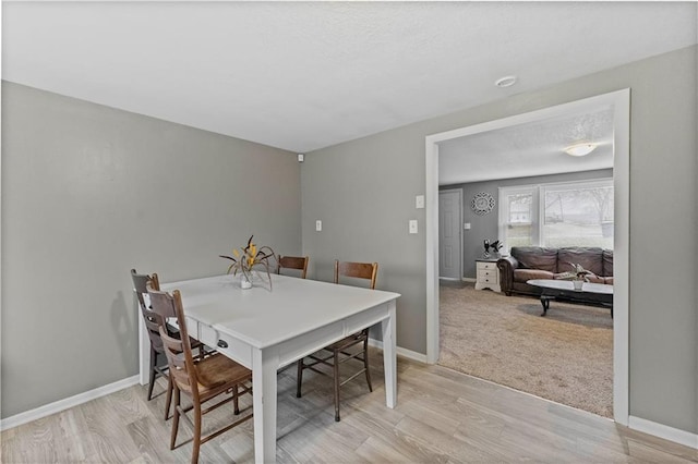 607 SW 8th St, Blue Springs, MO 64015 - dining room with light wood-style flooring, light colored carpet, baseboards, and a textured ceiling