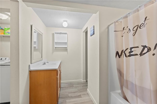 607 SW 8th St, Blue Springs, MO 64015 - full bath with washer / clothes dryer, a textured ceiling, wood finished floors, baseboards, and vanity