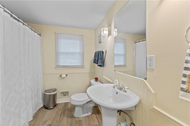 607 SW 8th St, Blue Springs, MO 64015 - bathroom with visible vents, toilet, wainscoting, wood finished floors, and a sink