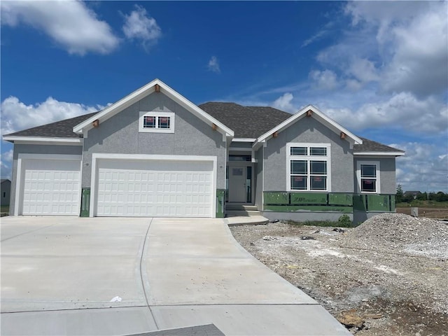 16487 W 166th Pl, Olathe, KS 66062 - view of front facade featuring a garage, stucco siding, concrete driveway, and a shingled roof