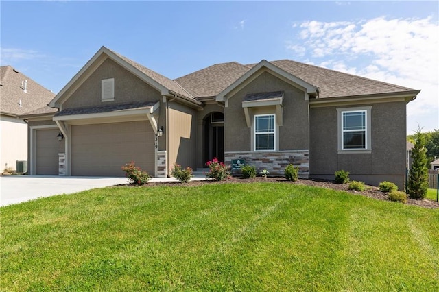 16487 W 166th Pl, Olathe, KS 66062 - view of front facade with an attached garage, a front yard, concrete driveway, roof with shingles, and stucco siding