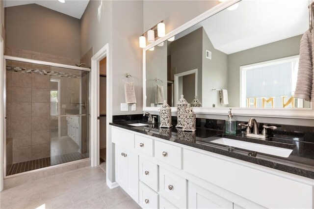 16487 W 166th Pl, Olathe, KS 66062 - full bath featuring double vanity, a shower stall, tile patterned flooring, and lofted ceiling
