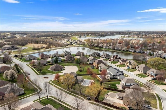 drone / aerial view with a water view and a residential view