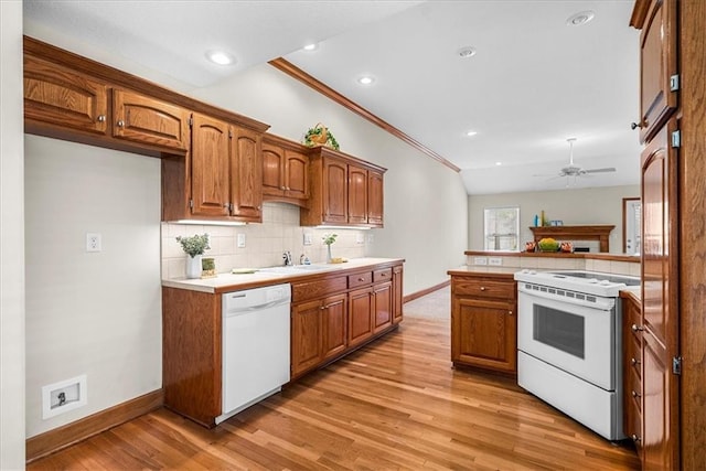 kitchen featuring tasteful backsplash, brown cabinets, white appliances, light wood-style floors, and ceiling fan